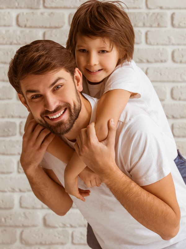 Explore Early Orthodontic Treatment Today! Dad with his young son smiling