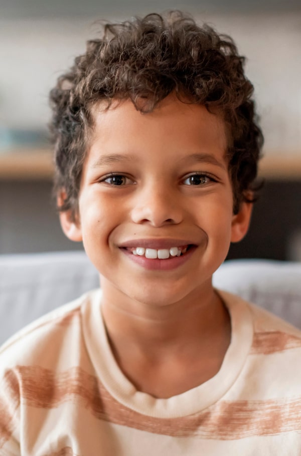 Find Out if Early Orthodontic Treatment Is Needed! A boy is happily smiling