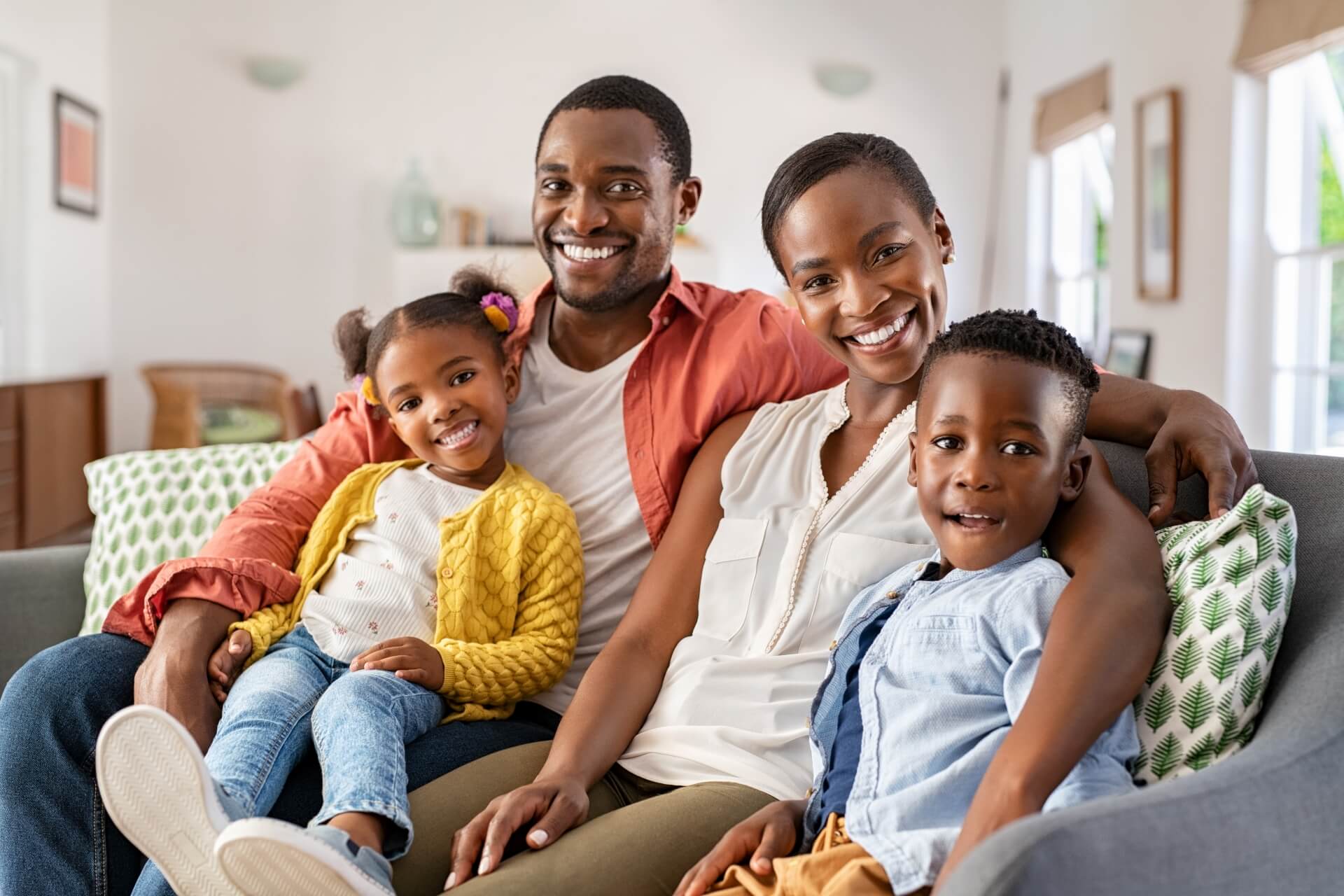 A happy family sitting on the couch