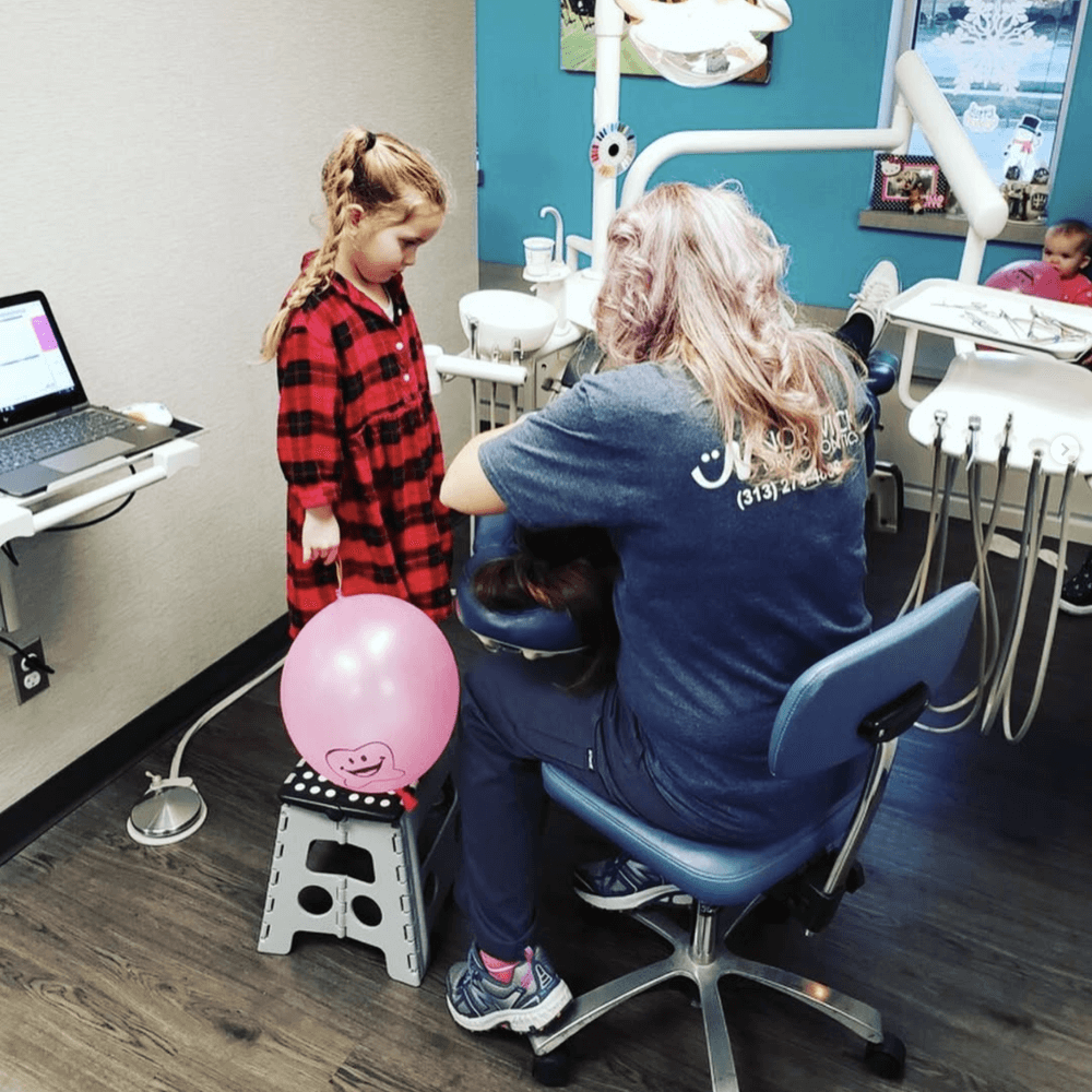 Little girl and doctor with doctor logo doing procedure