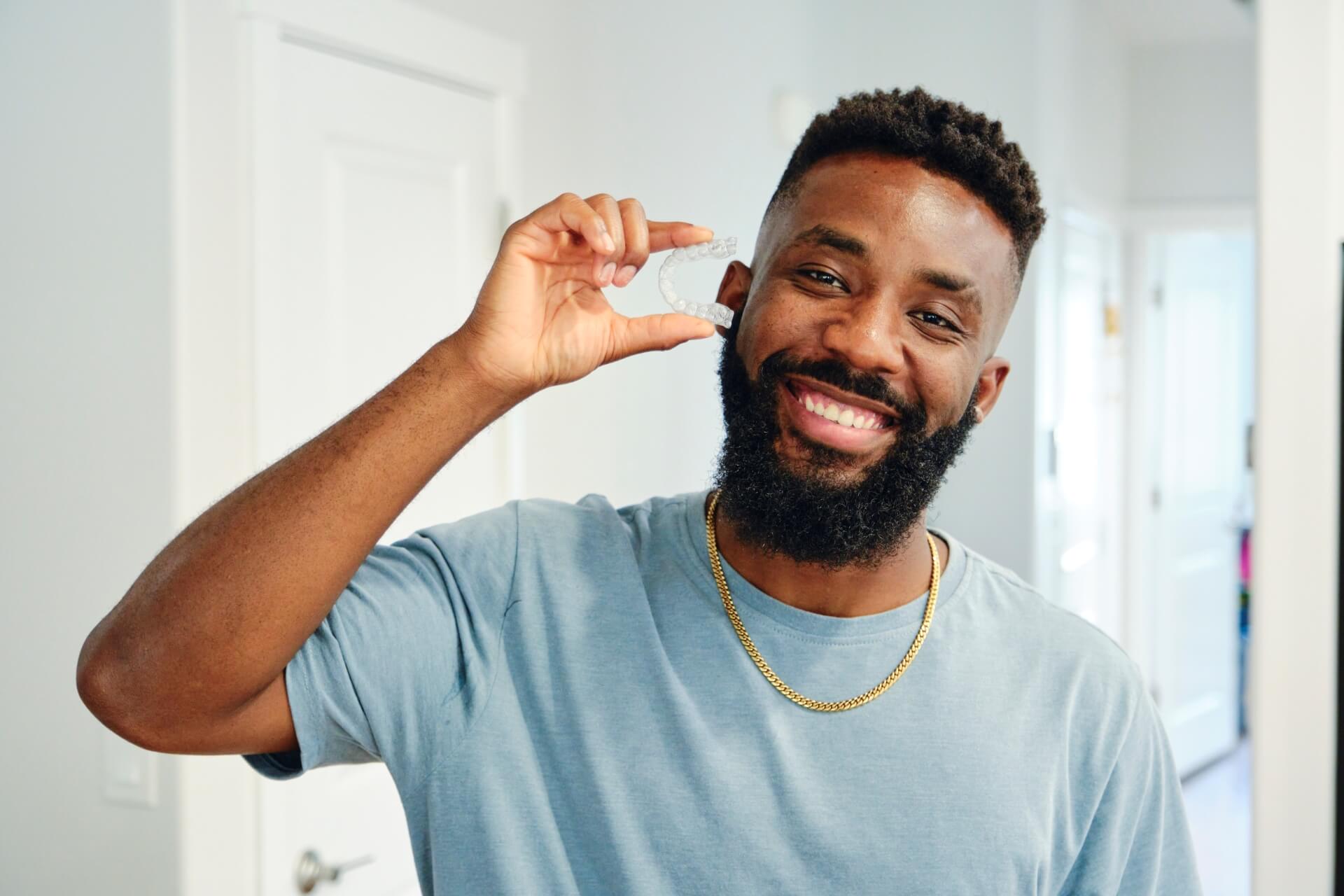 Man holding Invisalign in his hands