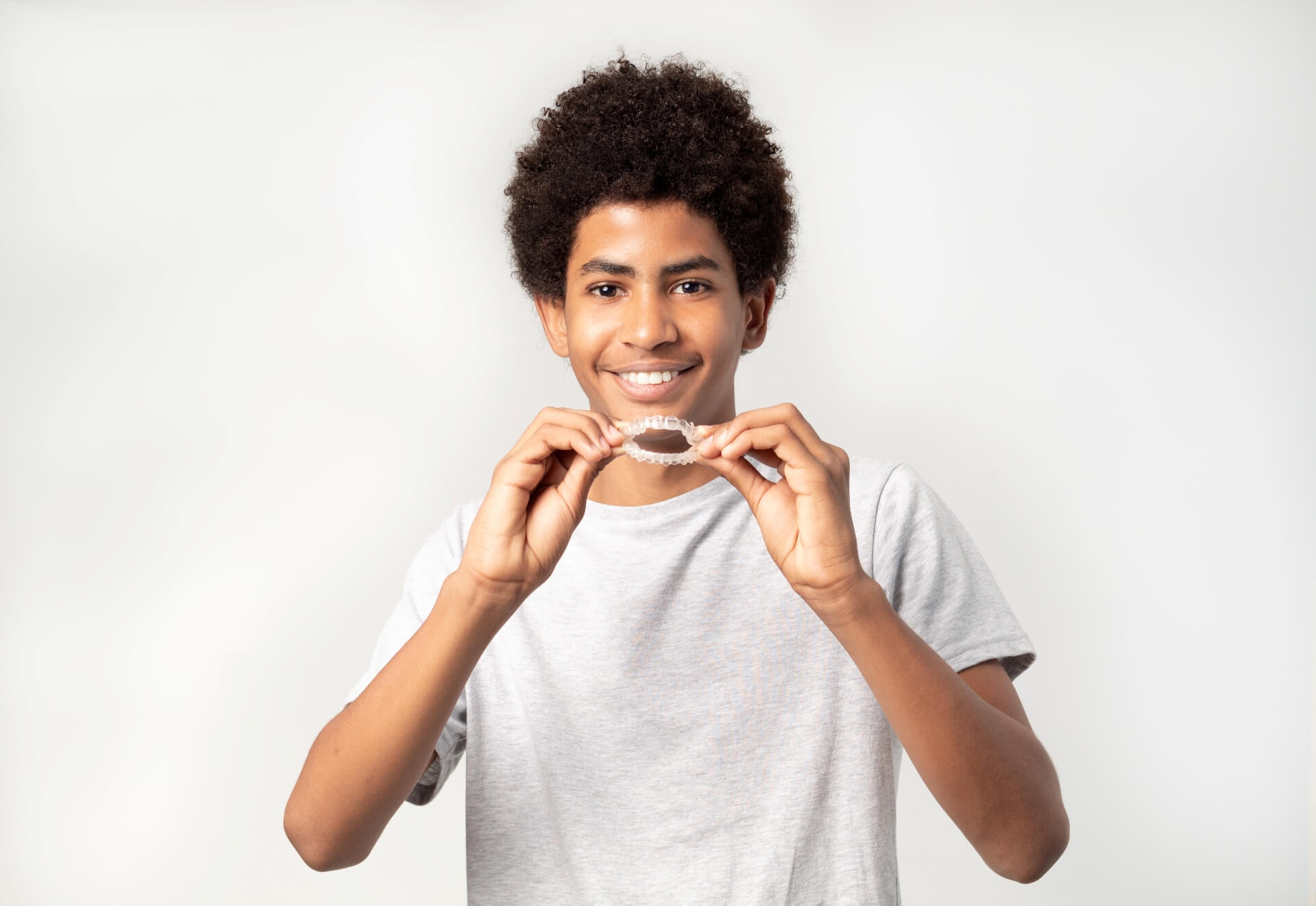 A boy holding Invisalign